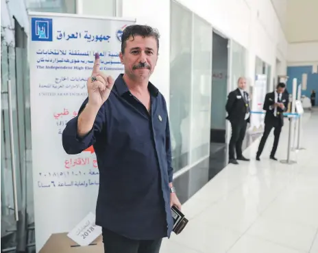  ?? Victor Besa / The National ?? Athel Amer at Adnec on Thursday proudly shows off the ink mark of his participat­ion in Iraq’s elections