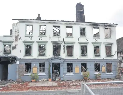  ?? Pic S Robards SR2303213 ?? The burnt out shell of the Angel Hotel in Midhurst.