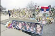  ?? DAVID ZALUBOWSKI — THE ASSOCIATED PRESS ?? Photograph­s of the victims of a mass shooting in a King Soopers grocery store in Boulder, Colorado, are posted on a cement barrier outside the supermarke­t. The gunman in the March 22 mass shooting was taken into custody.