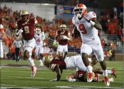  ?? AP PHOTO ?? Clemson running back Wayne Gallman (9) gets away from Boston College defensive back Kamrin Moore and linebacker Connor Strachan on a touchdown run.