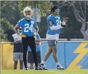  ?? Ringo H.W. Chiu Associated Press ?? NASIR ADDERLEY (24) and Derwin James Jr. watch the action during Chargers training camp.