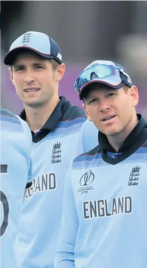  ??  ?? England’s Chris Woakes and Eoin Morgan. Left, injured Jofra Archer