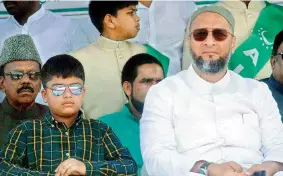  ??  ?? MIM president Asaduddin Owaisi and his son Salahuddin watch the 61st revival day celebratio­ns of the party in Hyderabad on Saturday.