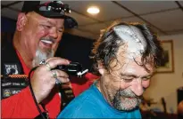  ??  ?? “Dino” Pace gets his hair shaved off during a fundraiser for Glen “Oink” Pierce on July 7 at Bastrop’s American Legion Post No. 533. The fundraiser is helping Pierce, a member of the Legion Riders, with his medical expenses while he recovers from a...