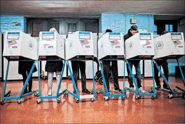  ?? Alexander F. Yuan Associated Press ?? VOTERS at a Brooklyn, N.Y., polling station in 2016. U.S. officials have expressed concern about hacking.