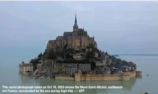  ?? — AFP ?? This aerial photograph taken on Oct 18, 2020 shows the Mont-Saint-Michel, northweste­rn France, surrounded by the sea during high tide.