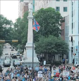  ?? Rainier Ehrhardt
Associated Press ?? PROTESTERS demand that the Confederat­e flag be removed from a war memorial at the Capitol in Columbia, S.C. A two-thirds vote by lawmakers is required.