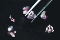  ?? ROBERT GILHOOLY/BLOOMBERG FILES ?? Rare pink diamonds are displayed at the Rio Tinto Diamonds office in Tokyo. Rio “has a deep experience and expertise in the diamond exploratio­n and mining business and looks forward to working on this growth opportunit­y,” it said Tuesday.