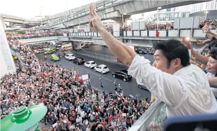  ?? BANGKOK POST ?? Thanathorn Juangroong­ruangkit, leader of the Future Forward Party, flashes an anti-coup gesture as he greets his supporters during a gathering last December in Pathumwan district of the capital.