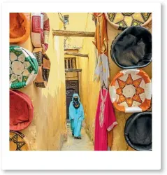  ?? ISTOCK/ PAVLIHA ?? A woman in blue djellaba walks through the medina in Fez.