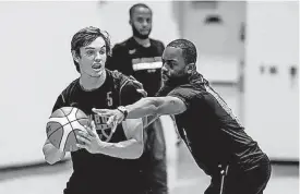  ?? THE OKLAHOMAN] [PHOTOS BY MITCHELL ALCALA, FOR ?? Oklahoma State coach Mike Boynton, right, guards freshman forward Duncan Demuth during the Cowboys’ first practice before its tour of Europe.