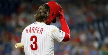  ?? CHRIS SZAGOLA — THE ASSOCIATED PRESS ?? The Phillies’ Bryce Harper adjusts his helmet while batting during the ninth inning.