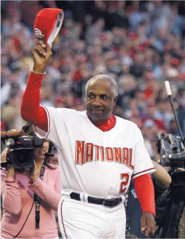  ?? AP FILE ?? Frank Robinson tips his cap to the crowd after being introduced as manager of the Washington Nationals in their 2005 home opener.