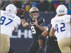  ?? The Associated Press ?? IN THE POCKET: Navy quarterbac­k Zach Abey (9) throws on Nov. 17 in Annapolis, Md., as he is pressured by Tulsa defensive tackle Tyarise Stevenson (97) and linebacker Cooper Edmiston (42) in the first half of a 37-29 win for the Midshipmen against the Golden Hurricane.