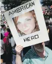  ?? MICHAEL DWYER, AP ?? A demonstrat­or holds a photo of Heather Heyer during a rally on Aug. 19, 2017.