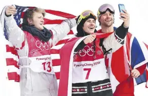  ?? JONATHAN HAYWARD/THE CANADIAN PRESS ?? Gold medallist Sebastien Toutant, centre, stretches out for a selfie with U.S. silver medallist Kyle Mack, left, and British bronze medallist Billy Morgan.