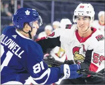  ?? CP PHOTO ?? Toronto Maple Leafs’ Mac Hollowell, left, checks Ottawa Senators’ Alex Formenton during first period NHL Rookie Showdown hockey action in Laval, Que., Sept. 8
