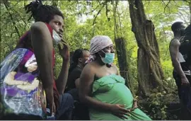  ??  ?? FRUSTRATED Haitians stuck in Tapachula joined a group of hundreds going north. When Mexican forces stopped the migrants, some escaped into the forest.