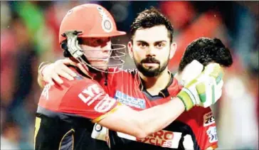  ?? DIBYANGSHU SARKAR/AFP ?? Royal Challenger­s Bangalore captain Virat Kohli (right) and AB de Villiers celebrate after beating Kolkata Knight Riders in the Indian Premier League on May 16, 2016.