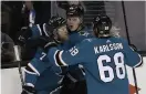  ?? Bild: JEFF CHIU ?? VIDARE. San Joses Marcus Sörensen, i mitten, hyllas för sitt mål av Paul Martin och Melker Karlsson i matchen mot Anaheim.