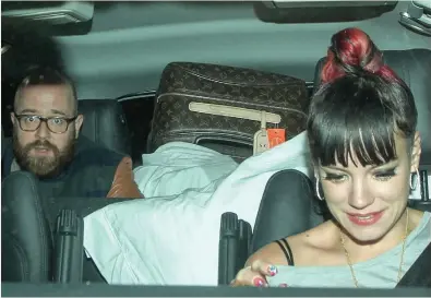  ??  ?? BACKING ACT: Lily leaving a London club on Friday night with sheepish-looking ex Seb Chew in the rear seat