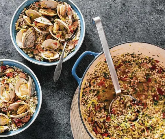  ?? Steve Klise / Associated Press ?? Pearl couscous, chorizo and leeks add a lot of flavor to steamed clams. Using dry vermouth to steam the clams adds some punch, but white wine also works well. This recipe appears in “The Complete Mediterran­ean Cookbook.”