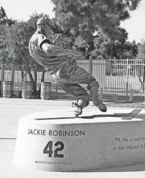  ?? KIRBY LEE/USA TODAY SPORTS ?? A Jackie Robinson statue sits in the center field plaza at Dodger Stadium.