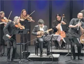  ?? Ben Gibbs ?? P L AY I N G together with the Knights are, foreground, from left, violinist Colin Jacobsen, Israeli mandolinis­t Avi Avital and Syrian clarinetis­t Kinan Azmeh.