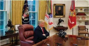  ?? (Leah Millis/Reuters) ?? US PRESIDENT Donald Trump answers a reporter’s question as eight different phones and recording devices placed on his desk by reporters and White House staff members record his words during an interview with Reuters in the Oval Office of the White House