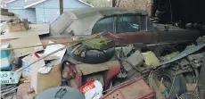  ??  ?? The Canadian-built automobile is almost hidden by boxes and old constructi­on material in owner Thiessen’s Abbotsford carport.