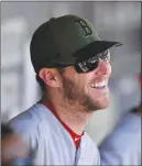  ?? AP PHOTO ?? Boston Red Sox pitcher Chris Sale jokes with teammates in the dugout before a game against the Chicago White Sox in Chicago.