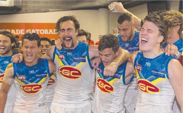  ?? Picture: AAP ?? INITIATION: Cairns junior Jacob Heron (second from right) as the Gold Coast Suns celebrate their comeback win over the Sydney Swans on Saturday.