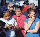  ?? DAMIAN DOVARGANES/AP ?? Parents wait at the Belmont High School in Los Angeles for news of students.