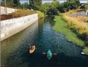  ?? PHOTO BY CHRIS SALAS ?? Carl Salas, left, and Mercury News columnist Sal Pizarro kayak on the Guadalupe River earlier this month.