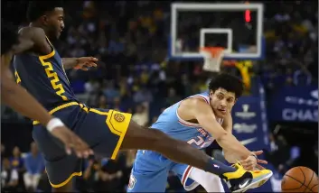  ?? AP PHOTO/BEN MARgOT ?? Sacramento Kings’ Justin Jackson (right) passes the ball around Golden State Warriors’ Jordan Bell during the first half of an NBA basketball game on Saturday, in Oakland, Calif.