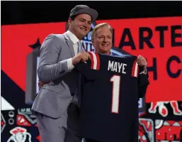  ?? Tribune News Service ?? Drake Maye, left, poses with NFL Commission­er Roger Goodell after being selected third overall by the New England Patriots during the first round.