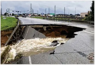  ?? ROSENBERG POLICE DEPARTMENT / ASSOCIATED PRESS ?? Heavy rain from Tropical Storm Harvey caused a sinkhole to open on FM 762 in Rosenberg near Houston on Aug. 27. State crews are working hard to repair roads.