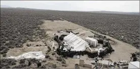  ?? KARL BRENNAN / DRONEBASE VIA AP ?? Three siblings and two other adults have been charged with child abuse stemming from the alleged neglect of 11 children found living on a squalid compound near Amalia, N.M., pictured Aug. 9, 2018. All five are being jailed without bail.