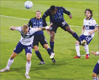  ?? The Canadian Press ?? Montreal Impact forward Romell Quioto heads in a goal over Vancouver Whitecaps midfielder Andy Rose, left, with Russell Teibert and Impact Samuel Piette looking on during first half MLS action in Montreal on Tuesday.