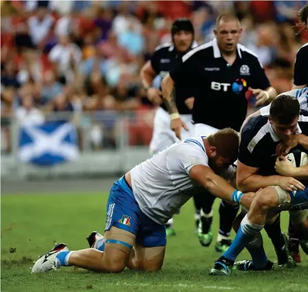  ??  ?? Scotland substitute Magnus Bradbury is tackled after coming on in place of Tim Visser in the Singapore