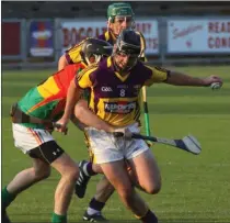  ??  ?? Wexford midfielder Eoin Moore breaking through a challenge.