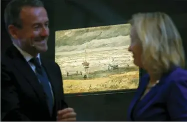  ?? PETER DEJONG — THE ASSOCIATED PRESS ?? Van Gogh Museum director Axel Rueger, left, and Jet Bussemaker, Minister for Education, Culture and Science, stand next to the stolen and recovered “Seascape at Schevening­en” by Dutch master Vincent van Gogh, during a press conference in Amsterdam on...