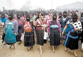  ?? EDUARDO VERDUGO/AP ?? Maria de Jesus Patricio, presidenti­al candidate for the National Indigenous Congress, campaigns with an escort of masked indigenous women in the Chiapas, Mexico.