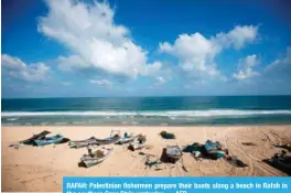  ??  ?? RAFAH: Palestinia­n fishermen prepare their boats along a beach in Rafah in the southern Gaza Strip yesterday. — AFP