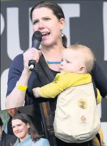  ??  ?? MUM OF TWO Swinson with the younger of her sons at a 2019 rally. Left, with husband Duncan Hames