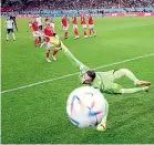  ?? ?? Left, Marcus Rashford pays tribute to a friend who recently died of cancer with this goal celebratio­n in England’s 3-0 win over Wales. Above, Wales goalkeeper Danny Ward can’t stop Rashford’s freekick.