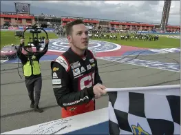  ?? WILL LESTER — THE ASSOCIATED PRESS FILE ?? Alex Bowman accepts the checkered flag from an official after winning a NASCAR Cup Series race on March 1 in Fontana.