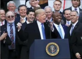  ?? MANUEL BALCE CENETA — THE ASSOCIATED PRESS FILE ?? House Speaker Paul Ryan of Wis., back left center, and other lawmakers react as President Donald Trump speaks about the passage of the tax overhaul bill on the South Lawn at the White House in Washington.