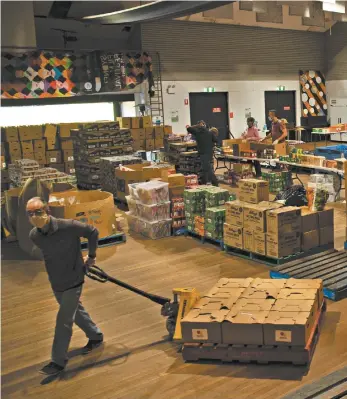  ?? Matthew Abbott ?? Volunteers organising food hampers in the Addi Road Food Relief Hub.