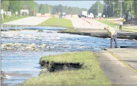  ?? MATT BORN — THE STAR-NEWS VIA AP ?? Flooding from Sutton Lake has washed away part of U.S. 421 in New Hanover County just south of the Pender County line in Wilmington, N.C., on Friday.